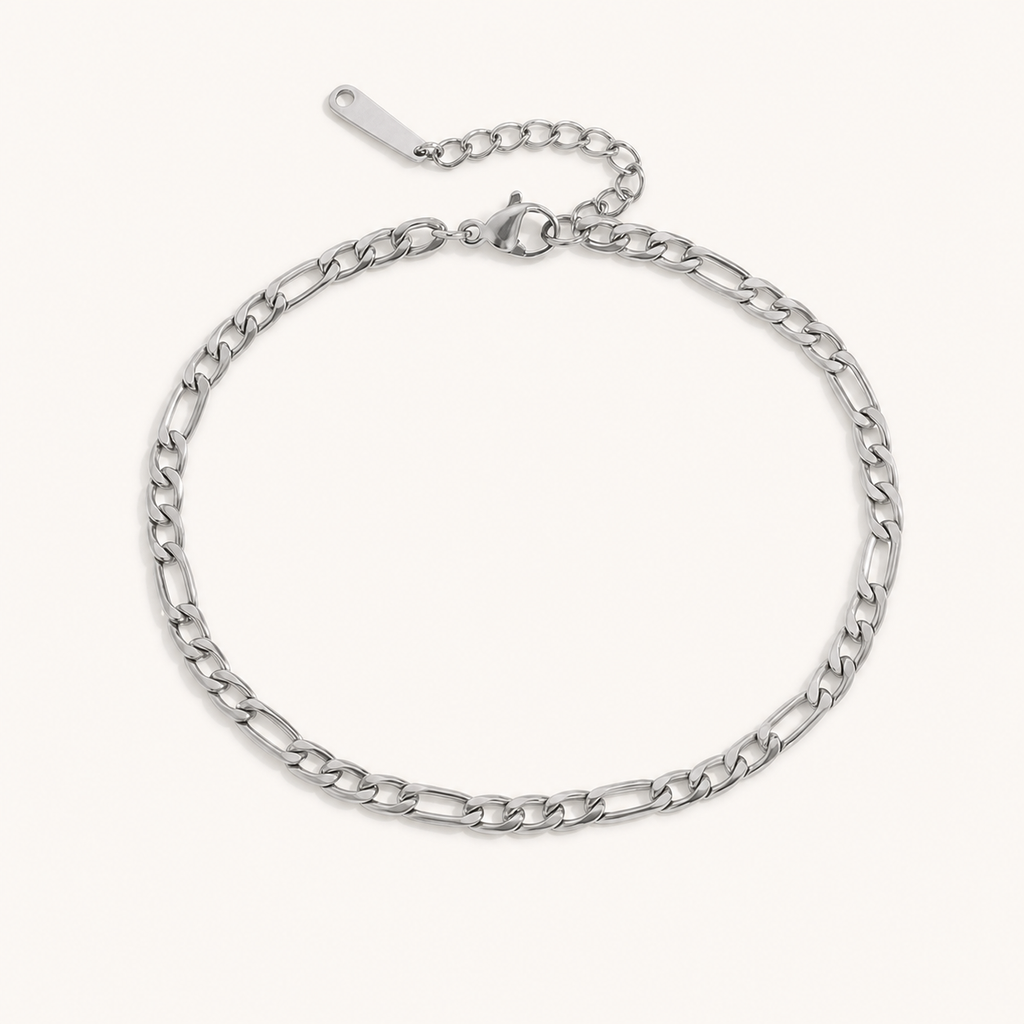 Silver-tone titanium steel Figaro chain anklet on an off-white background