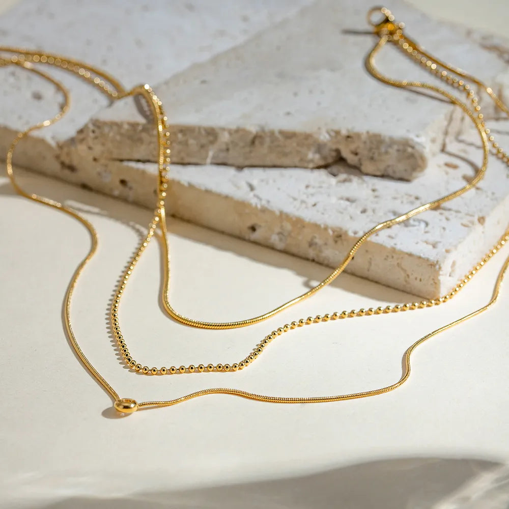 Detalhe das correntes do colar camadas dourado